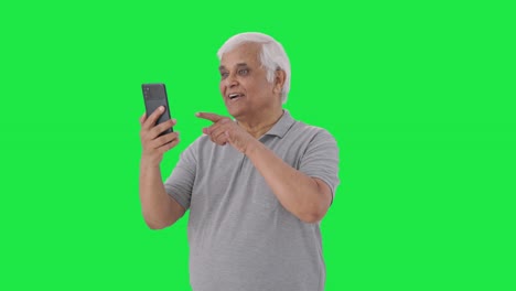 Happy-Indian-old-man-talking-on-video-call-Green-screen