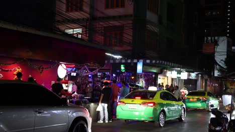 vibrant urban night with cars and pedestrians