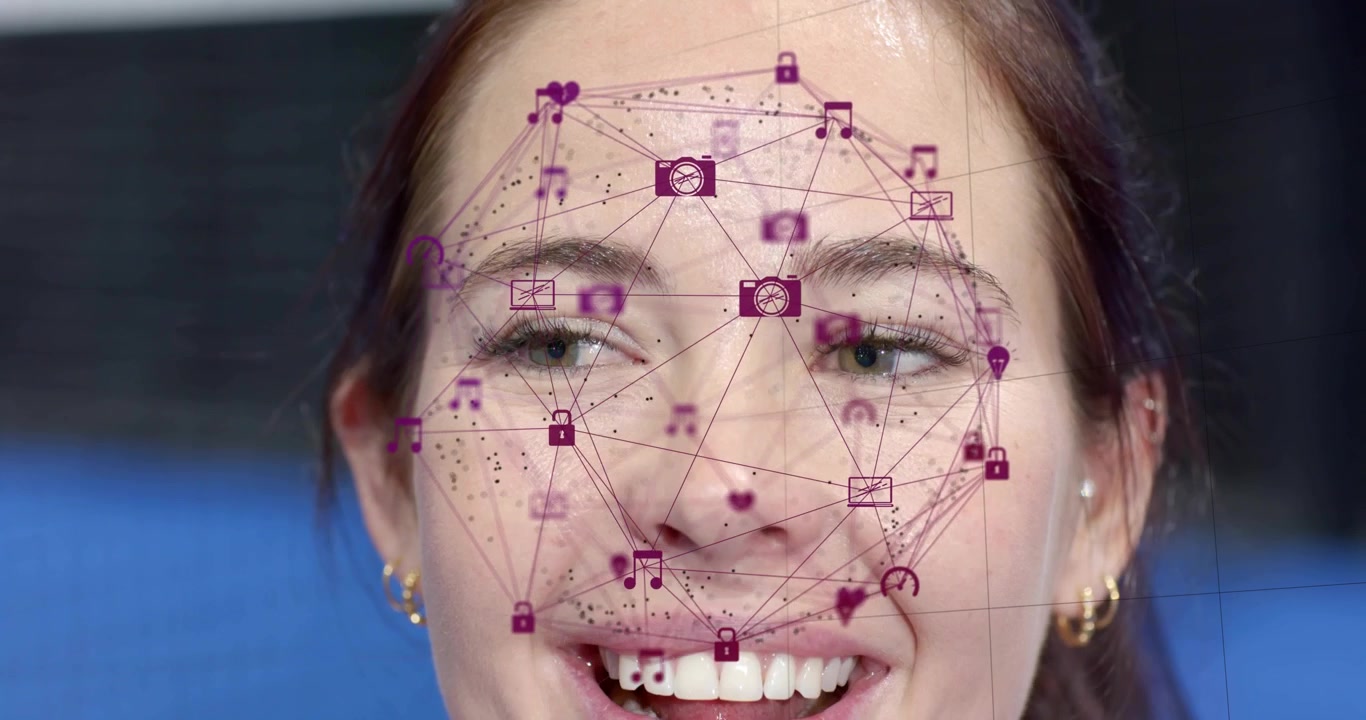 Woman facing camera in tech demo, blinking and shifting gaze while purple icons tracking moves