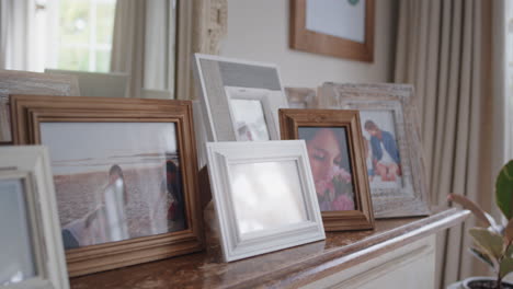 family-photos-picture-frames-on-fireplace-collection-of-photographs-happy-memories-4k