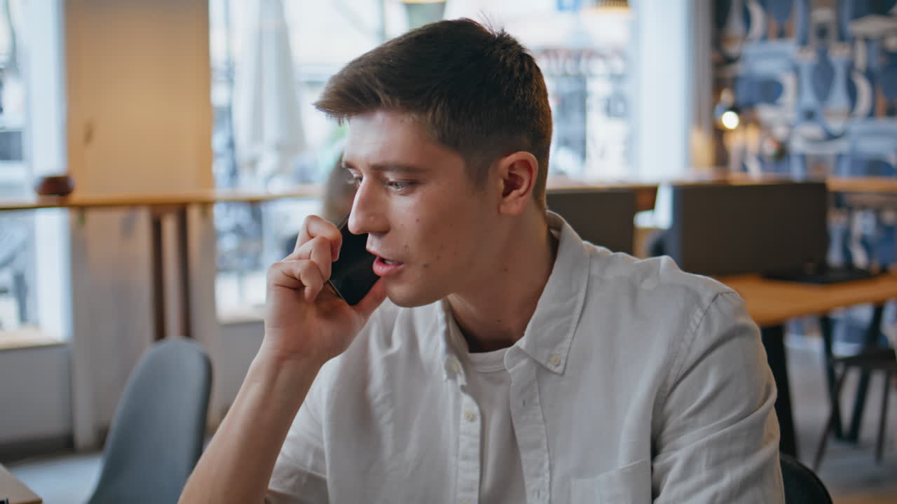 Closeup office worker calling mobile phone sitting. Manager talking smartphone