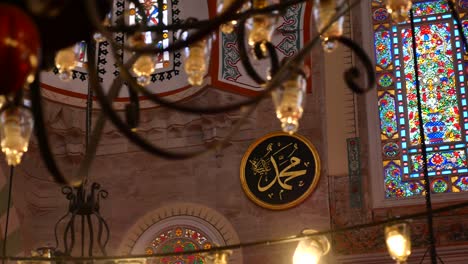 interior of a mosque with stained glass windows and calligraphy