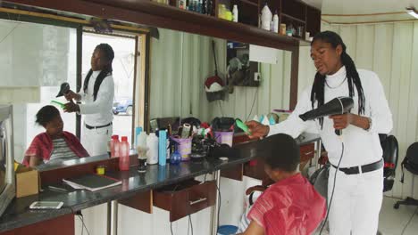 hombre africano peinando el cabello de una mujer africana