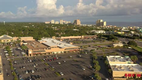 drone view flying over silver sands outlet mall in destin florida with a view of the gulf of mexico