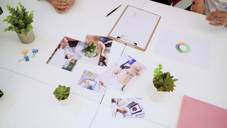 unrecognizable coworkers examining photos in office