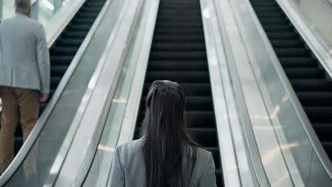 escalator, business woman and back in office lobby