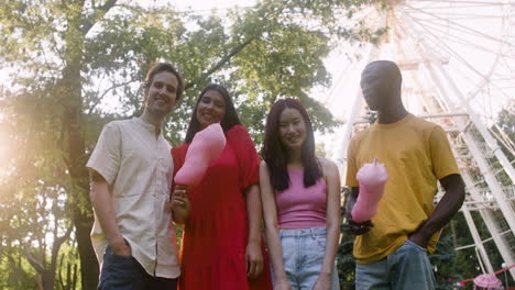 four people posing in a park