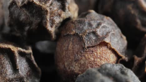 peppercorns or black pepper spice. super macro close up.