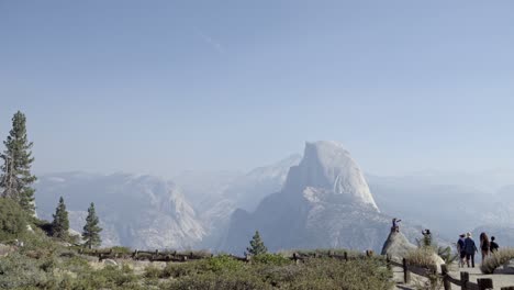 a boy on a rock at glacier point yosemite national park  half dome and the sierra nevada mountains in the distance 1