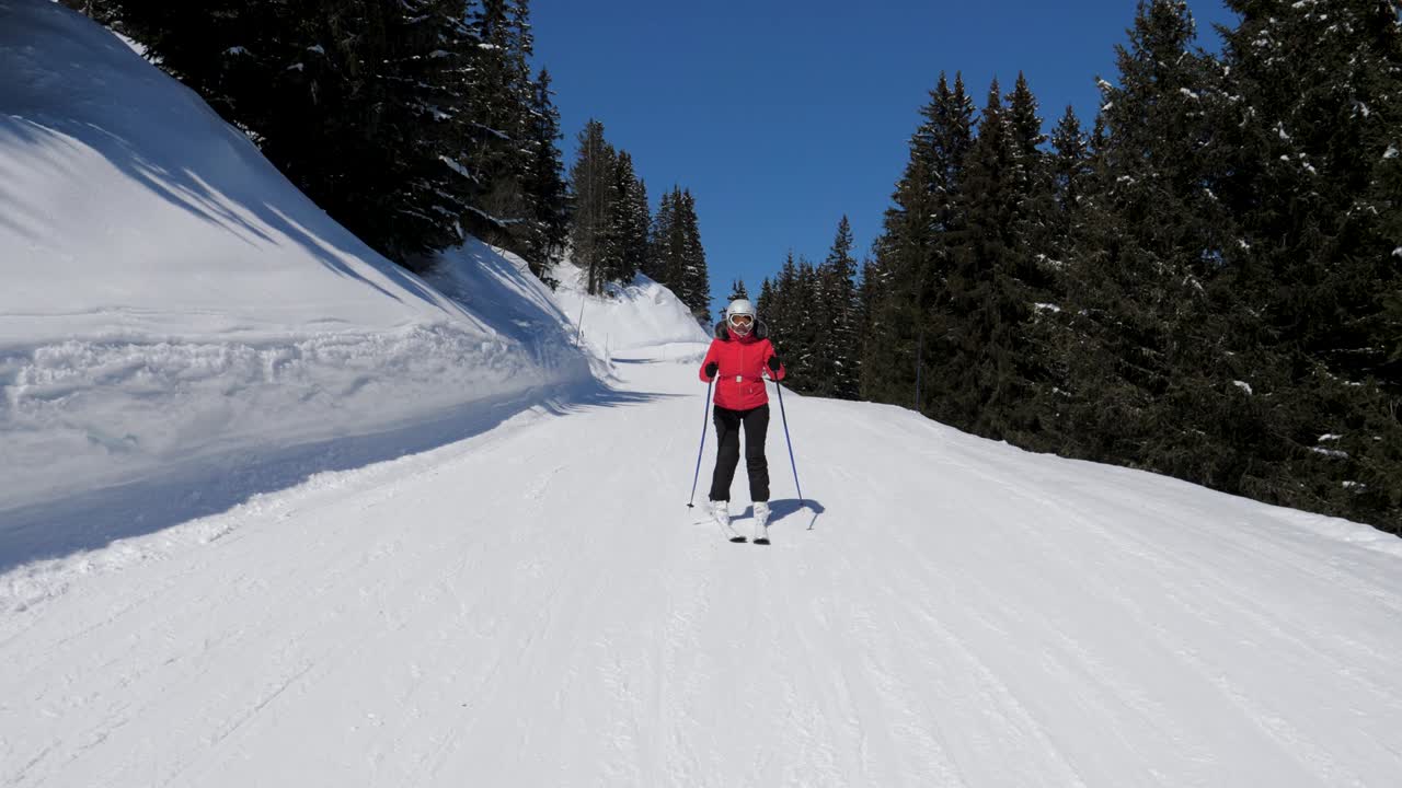 Sciatore maturo attivo scende con gli sci lungo il pendio della montagna in un paesaggio invernale da favola