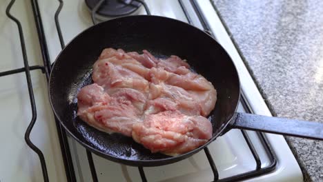 chicken being cooked in pan and adding ingredients to flavour