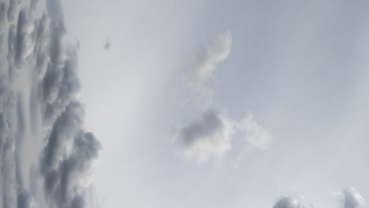 Dramatic grey skies before the rainfall. Rainy clouds floating. Low angle view. Timelapse. Vertical screen.