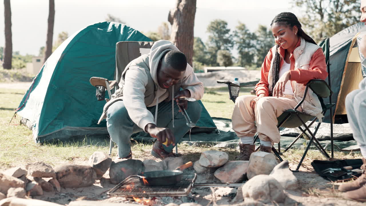 Friends Camping and Cooking Outdoors