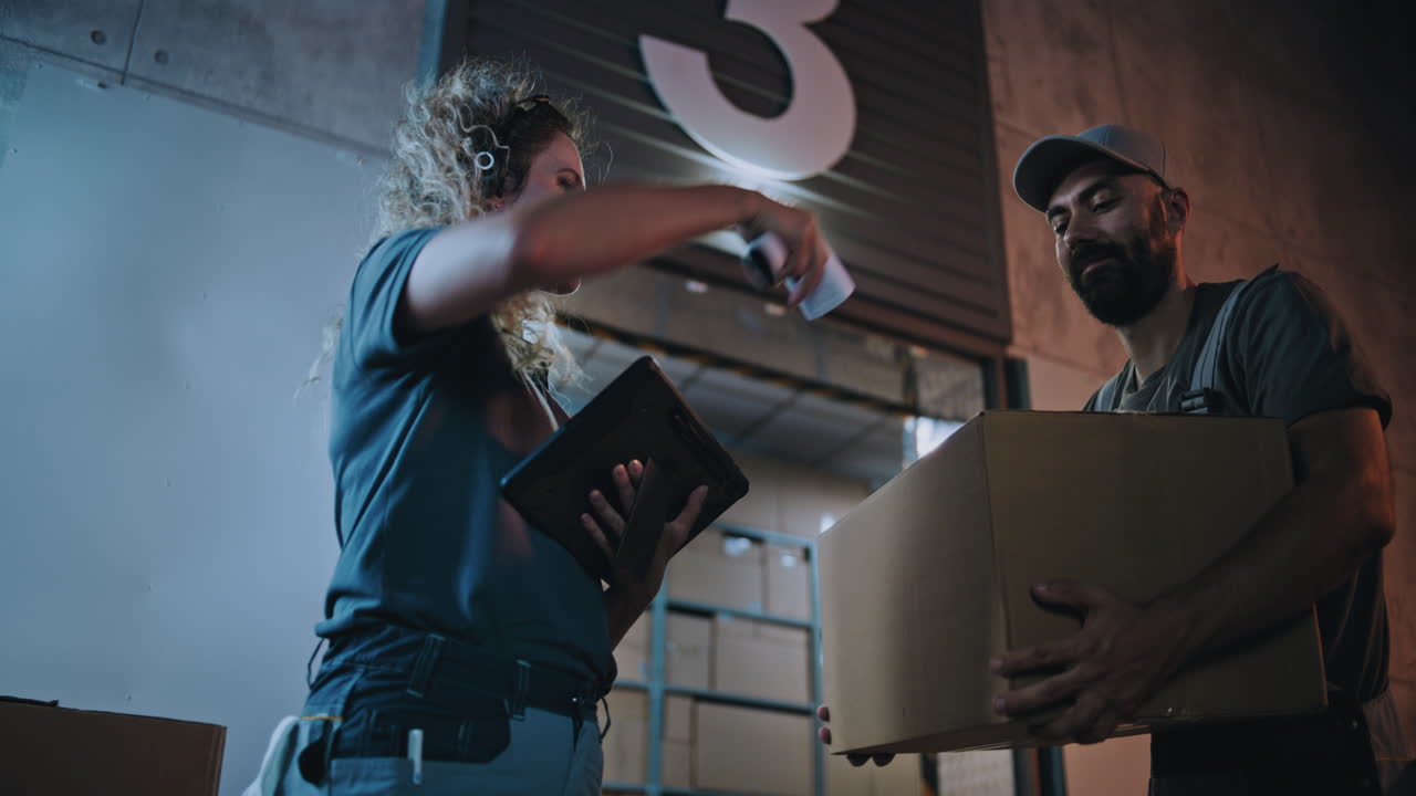 Diverse Employees Carrying Cardboard Boxes to Logistics Warehouse Female Coordinator Scanning