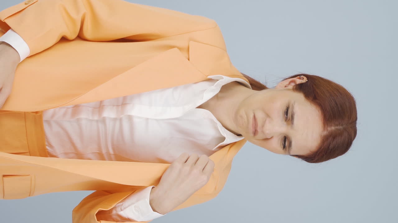 ⁇   ⁇ 새를 맡는 사업가 여성의 수직 비디오가 카메라에 부정적인 표현을합니다.