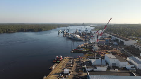 Descending-aerial-shot-of-the-empty-dry-dock-at-the-Bath-Iron-Works,-showing-the-River-Kennebec,-Clear-day