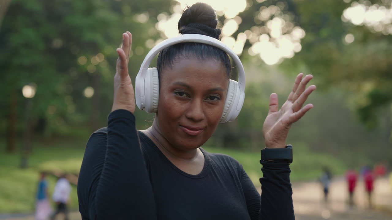 Woman exercising with headphones in the park