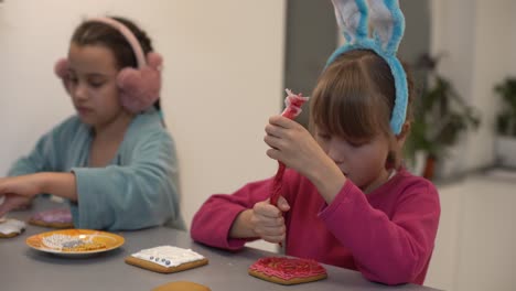 dos niñas haciendo galletas de jengibre en casa.
