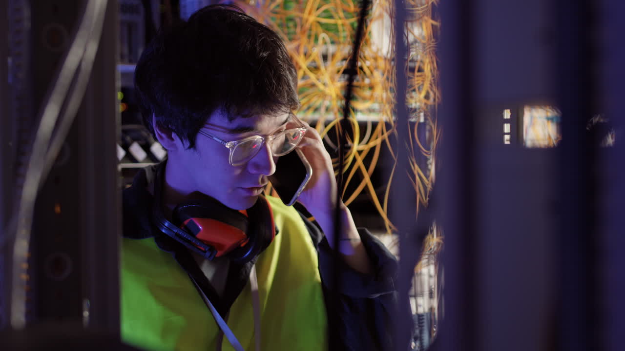 IT Administrator Making Telephone Call in Data Center