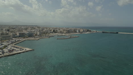 A-drone-captures-the-stunning-coastline-of-Corinth,-Greece,-offering-a-breathtaking-aerial-view-of-the-city's-beauty