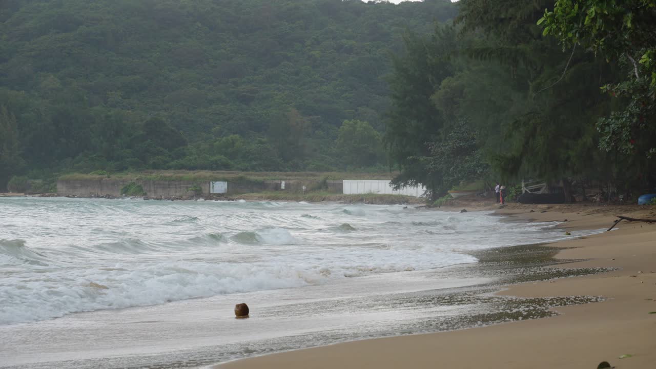 Weaves on Dam Trau Beach rolling into Seashore On A Cloudy Day In Con Dao, Vietnam