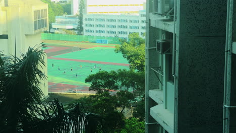 a-group-of-people-playing-football-in-the-distance-far-from-the-house