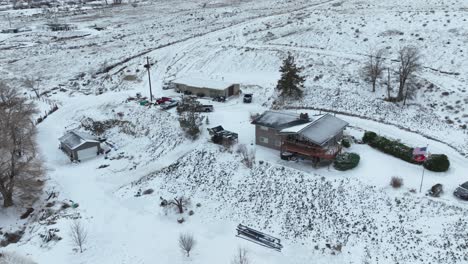 drone shot of a rural house covered in a fresh layer of snow