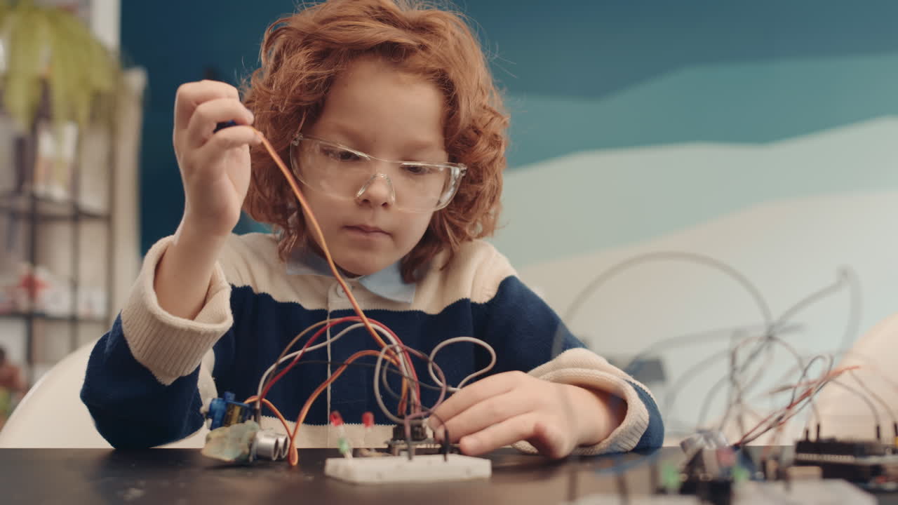 Young boy focused on an electronics project