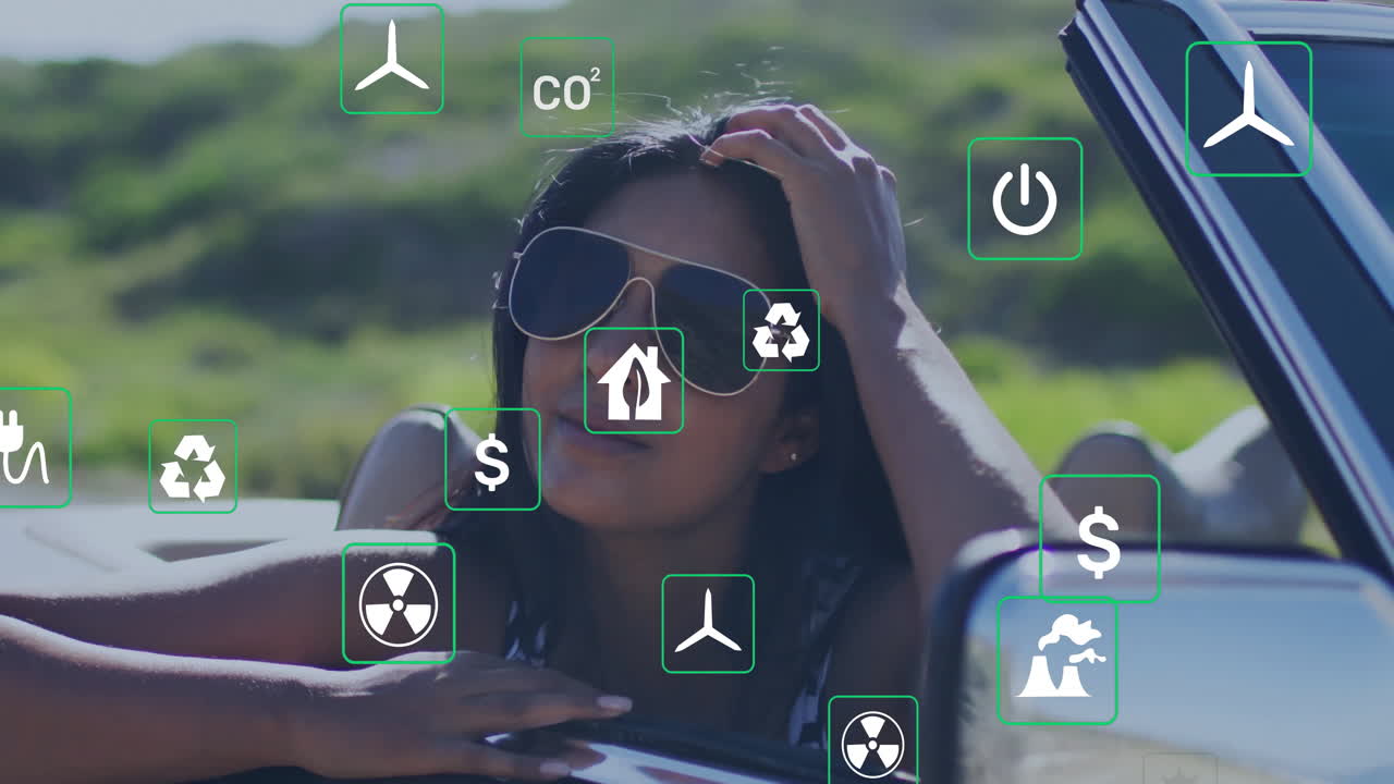 woman leaning out of red convertible cruising rural road, displaying energy technology icons