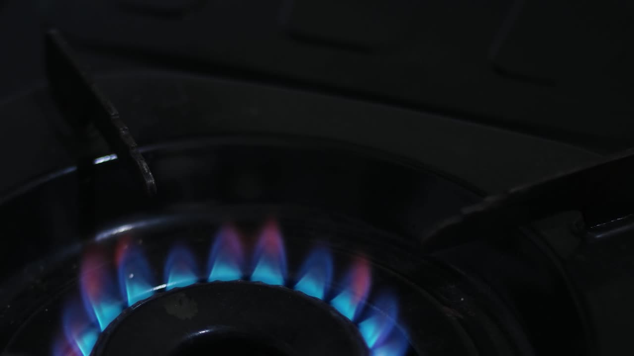 close up of placing a frying pan on the stove
