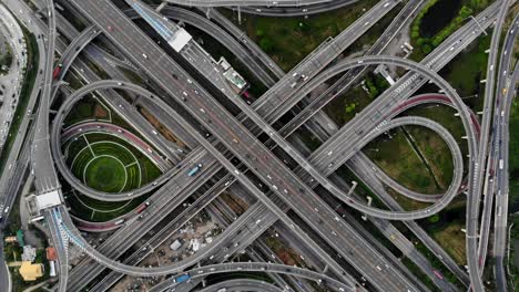 high angle looking top down view of complicate road and expressway intersection in bangkok city of thailand. shot by drone can use for transportation or abstract concept.