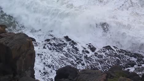 time rewinds as waves roll away from the rocks, high angle