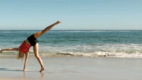 Woman-doing-a-cartwheel-on-the-beach