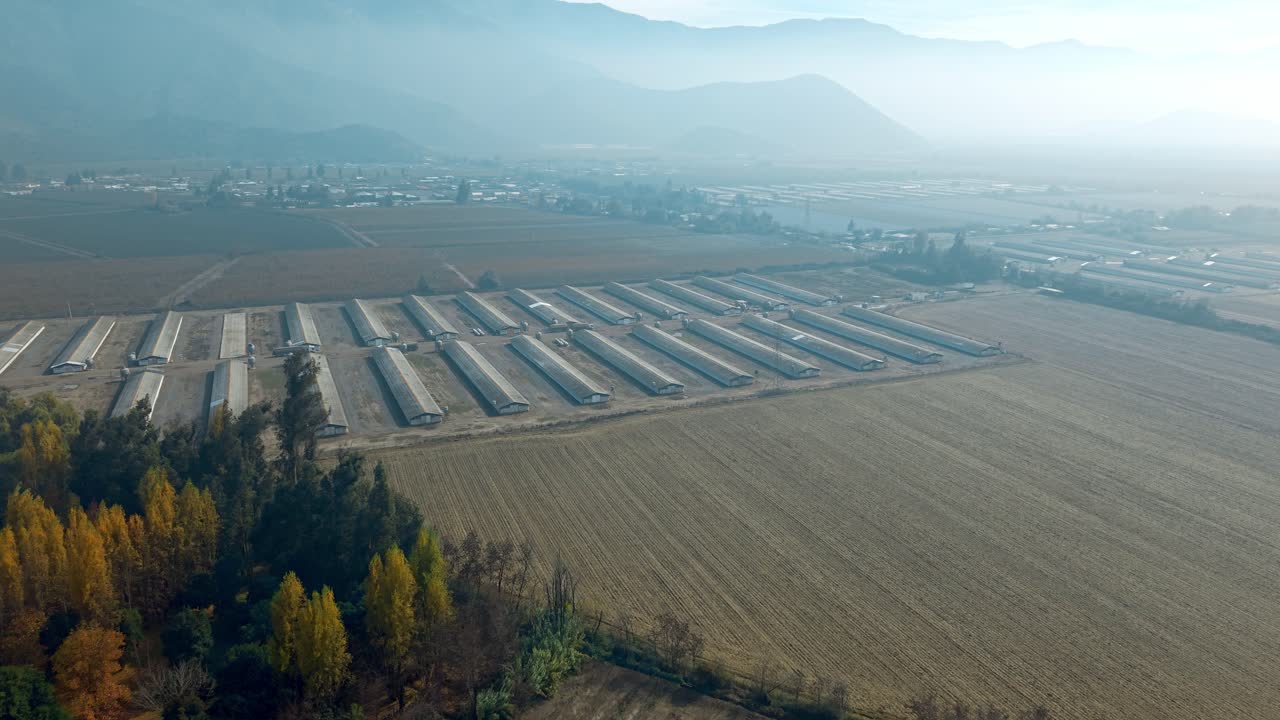 Warehouses at Rancagua suburbs in wide aerial shot on a hazy autumn morning