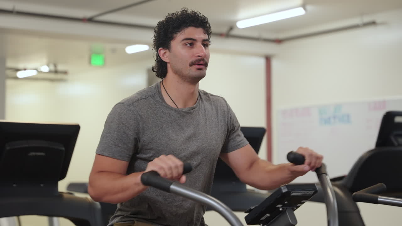 Man Doing Assault Bike Workout - Full-body Workout, Cardiovascular, And Efficient Calorie Burning