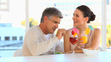 middle aged couple drinking cocktails