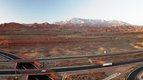 aerial view of a desert highway interchange with snow-capped mountains