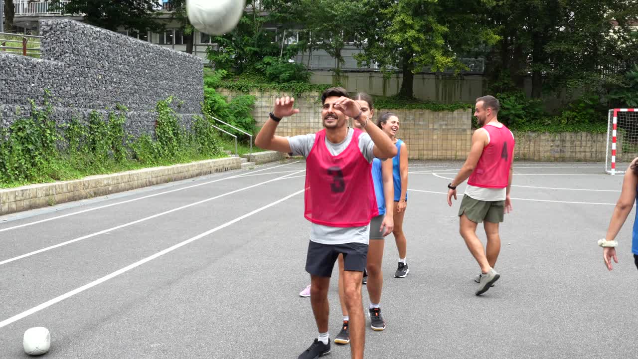 Group of people playing soccer in an urban setting