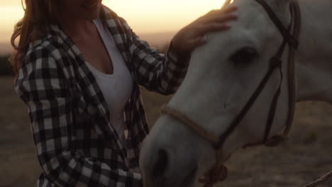 cowgirl and horse at sunset