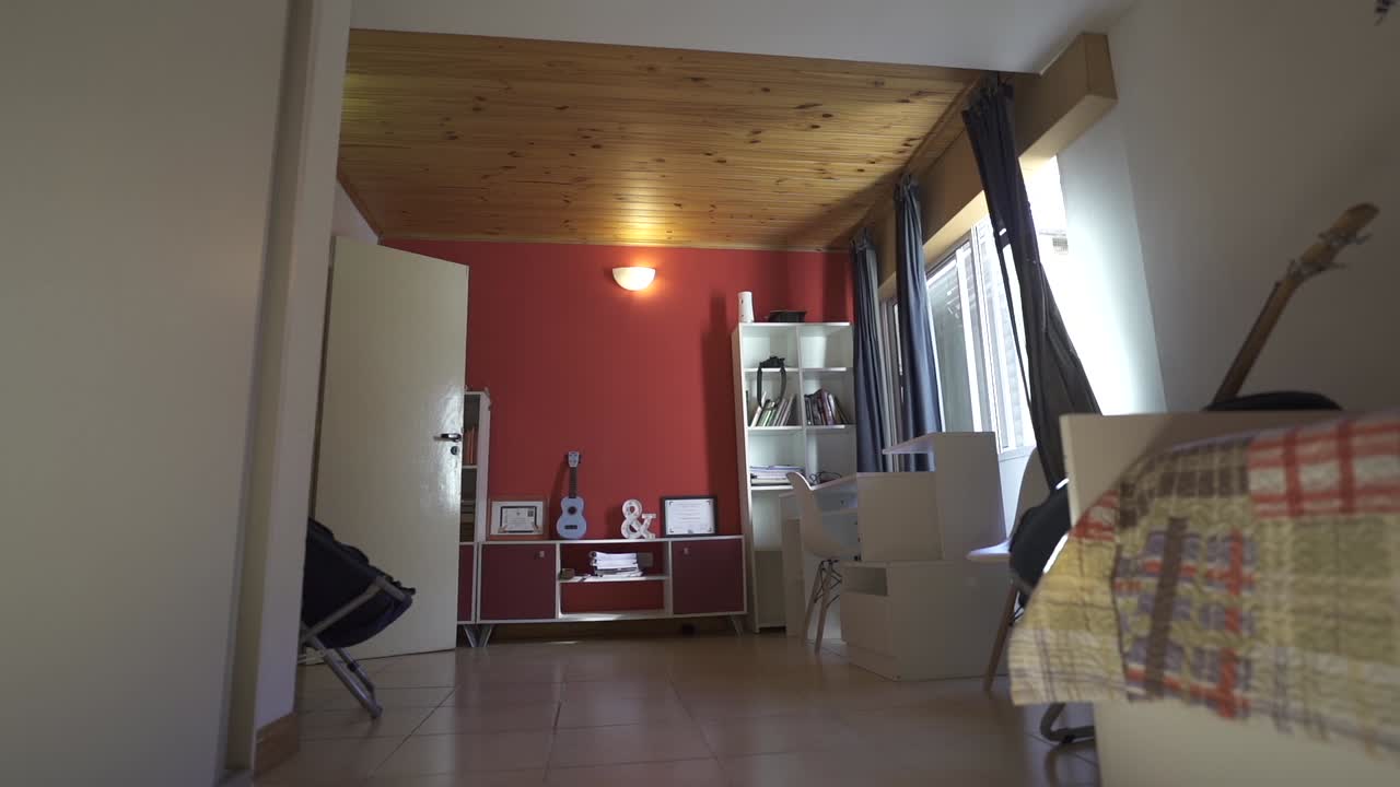 Vibrant red and white Airbnb bedroom, highlighting the statement guitars, decor, and cozy layout. Perfect for creative rental listings.