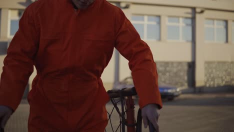 dock worker in orange uniform stepping to the ship bridge and getting on board of the ship