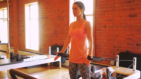 Woman-exercising-on-gym-equipment