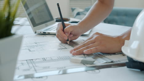 Architect working on blueprints