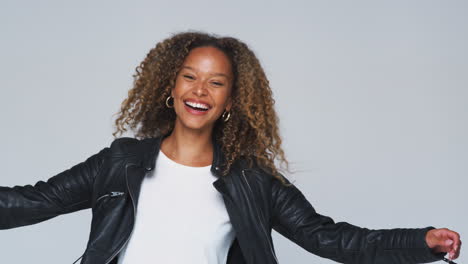 Waist-Up-Studio-Shot-Of-Young-Woman-Wearing-Leather-Jacket-Dancing-In-Slow-Motion