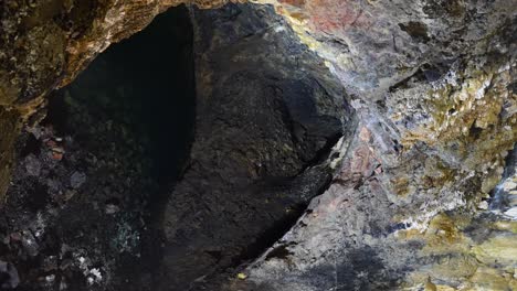 high angle shot of volcanic cave filling with water in algar do carvao