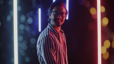 stylish man in striped shirt under neon lights