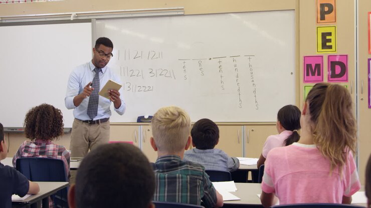 Tilt shot of teacher using tablet in math class, shot on R3D
