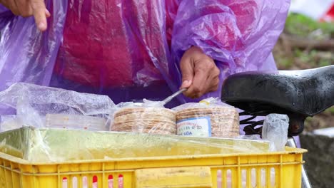 vendor preparing traditional snacks in hanoi, vietnam