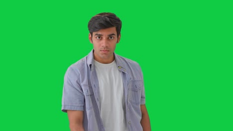 angry indian boy shows middle finger green screen