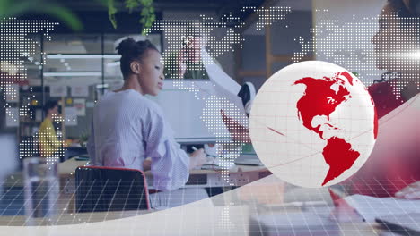 at desk, businesswoman working with global network animation overlay in office